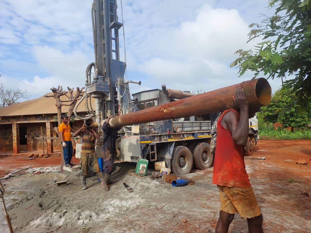 Drilling team operating rigs during well installation